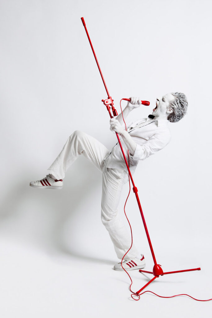 portrait d un homme en blanc criant dans un micro
