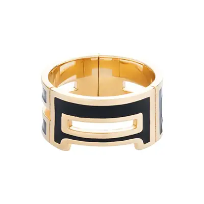 Photo produit d’une bague noire et dorée, vue face, sur fond blanc, prise en studio.